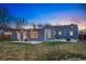 Backyard featuring a stone patio, well-manicured lawn, string lights, and outdoor seating at 4720 Perry St, Denver, CO 80212