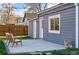 Backyard patio with seating, exterior doors and windows, plus fencing and beautiful green grass at 4720 Perry St, Denver, CO 80212