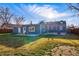 Large backyard with an inviting patio area, comfortable seating, and atmospheric string lights at 4720 Perry St, Denver, CO 80212