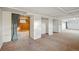 Unfinished basement with carpet, brick accent wall, and closet space, ready for personalization at 4720 Perry St, Denver, CO 80212