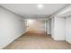 Spacious basement area with carpet, white walls, and potential for storage or customization at 4720 Perry St, Denver, CO 80212