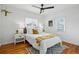 Cozy bedroom with hardwood floors, ceiling fan, and natural light from windows at 4720 Perry St, Denver, CO 80212
