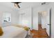 Cozy bedroom with hardwood floors, ceiling fan, and walk-in closet at 4720 Perry St, Denver, CO 80212