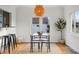 Bright dining room featuring hardwood floors, natural light, and woven area rug at 4720 Perry St, Denver, CO 80212