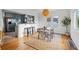 Bright dining area connecting to an open kitchen, featuring modern lighting and a natural fiber rug at 4720 Perry St, Denver, CO 80212