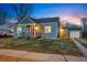 Cozy home with an inviting exterior, detached garage, and a well-kept lawn at 4720 Perry St, Denver, CO 80212