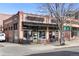 A beautiful brick building featuring Tenn Street Coffee and Books with large storefront windows, with seating in front at 4720 Perry St, Denver, CO 80212