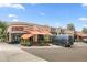 Exterior shot of the restaurant Fati Gays Inn with outdoor seating under orange awnings and a black van parked out front at 4720 Perry St, Denver, CO 80212