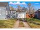 Detached garage accessible by a long driveway, surrounded by lush lawn at 4720 Perry St, Denver, CO 80212