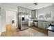 Bright kitchen featuring stainless steel refrigerator and updated cabinetry at 4720 Perry St, Denver, CO 80212