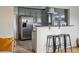 Open concept kitchen with stainless steel appliances and eat-in breakfast bar at 4720 Perry St, Denver, CO 80212