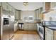 Bright kitchen featuring stainless steel appliances and updated cabinetry at 4720 Perry St, Denver, CO 80212