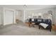 Spacious living room with neutral walls and carpet, and stairs to an upper level at 4720 Perry St, Denver, CO 80212