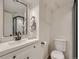 A modern bathroom featuring a vanity with a mirror and a toilet with a white finish at 3645 S Fox St, Englewood, CO 80110
