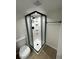 A stylish bathroom featuring a glass shower enclosure and a toilet with a white finish at 3645 S Fox St, Englewood, CO 80110