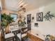 Cozy dining area with a modern light fixture, hardwood floors, and charming decor at 3645 S Fox St, Englewood, CO 80110