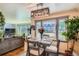 Charming dining area with a wooden table set, hardwood floors, and windows with outdoor views at 3645 S Fox St, Englewood, CO 80110