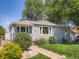 Charming single-story home with well-maintained lawn, lush landscaping, and a welcoming walkway at 3645 S Fox St, Englewood, CO 80110
