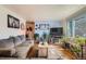 Bright living room with hardwood floors, a comfortable sofa, large windows, and decorative artwork at 3645 S Fox St, Englewood, CO 80110