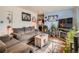 Warm living room featuring hardwood floors, a comfortable sofa, and stylish decorative elements at 3645 S Fox St, Englewood, CO 80110