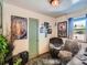 Office space featuring natural lighting, desk, decorations, and a green door at 3645 S Fox St, Englewood, CO 80110
