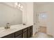 Bathroom features double sinks, modern vanity, and large mirror and lighting at 747 Sunflower Dr, Brighton, CO 80601