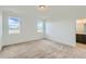 Bright bedroom with two windows, neutral carpet, and adjoining bathroom at 747 Sunflower Dr, Brighton, CO 80601