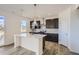 Modern kitchen with a center island, modern lighting, stainless appliances, and custom cabinetry at 747 Sunflower Dr, Brighton, CO 80601