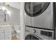 Bright, renovated bathroom with stacked washer and dryer, and modern fixtures at 857 S Van Gordon Ct # H101, Lakewood, CO 80228