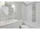 Bright bathroom featuring new tile, round mirror, modern fixtures, and white vanity at 857 S Van Gordon Ct # H101, Lakewood, CO 80228