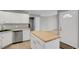 Bright kitchen featuring a central island with butcher block, stainless steel appliances, and abundant cabinet space at 857 S Van Gordon Ct # H101, Lakewood, CO 80228