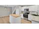 Bright kitchen features stainless steel appliances, white cabinets, and a butcher block island at 857 S Van Gordon Ct # H101, Lakewood, CO 80228