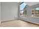 Bright, empty living room with hardwood floors and ample natural light from large windows at 857 S Van Gordon Ct # H101, Lakewood, CO 80228