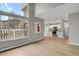 Open-concept living space with hardwood floors, white trim, and large windows throughout at 857 S Van Gordon Ct # H101, Lakewood, CO 80228