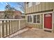 Private front patio with railing, fresh neutral paint, and red front door enhances curb appeal at 857 S Van Gordon Ct # H101, Lakewood, CO 80228