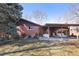 A spacious backyard featuring a covered patio with a swing and white patio set, perfect for relaxation at 1288 S Drexel Way, Lakewood, CO 80232