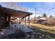 Enjoy outdoor living on the covered patio with a swing and a view of the backyard at 1288 S Drexel Way, Lakewood, CO 80232