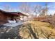 Enjoy outdoor living on the covered patio in this spacious backyard with a swing and white patio set at 1288 S Drexel Way, Lakewood, CO 80232