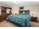 Comfortable bedroom with wood furniture, a window, and soft lighting for a relaxing atmosphere at 1288 S Drexel Way, Lakewood, CO 80232