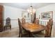 View of the dining room featuring a large wooden table and traditional chandelier at 1288 S Drexel Way, Lakewood, CO 80232