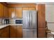 Kitchen view of the granite countertops, stainless steel refrigerator, and wood cabinets at 1288 S Drexel Way, Lakewood, CO 80232