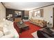 Inviting living room featuring a fireplace, a large window, and comfortable seating at 1288 S Drexel Way, Lakewood, CO 80232