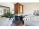 Comfortable living room showing fireplace with traditional mantel, neutral carpet, and large mirror at 1288 S Drexel Way, Lakewood, CO 80232