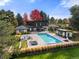 Aerial view of stunning estate featuring a pool, patio, fire pit, and cabana surrounded by lush landscaping at 5275 S University Blvd, Greenwood Village, CO 80121