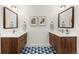 Bathroom with a double sink wood vanity, framed mirrors and blue tiled floors at 5275 S University Blvd, Greenwood Village, CO 80121