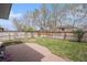 Fenced backyard with a brick patio and green grass, perfect for relaxing or entertaining guests at 9626 Whitecliff Pl, Highlands Ranch, CO 80129