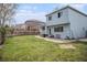 Spacious backyard with a well-maintained lawn, wooden fence, patio area, and plenty of space for activities at 9626 Whitecliff Pl, Highlands Ranch, CO 80129