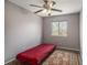 Simple bedroom with a red futon mattress on a metal frame and a patterned rug at 9626 Whitecliff Pl, Highlands Ranch, CO 80129