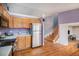 Galley kitchen featuring stainless steel appliances, natural wood cabinets, and hardwood floors at 9626 Whitecliff Pl, Highlands Ranch, CO 80129