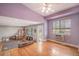 Living area featuring hardwood floors, lots of light, neutral decor and transition to carpeted area at 9626 Whitecliff Pl, Highlands Ranch, CO 80129